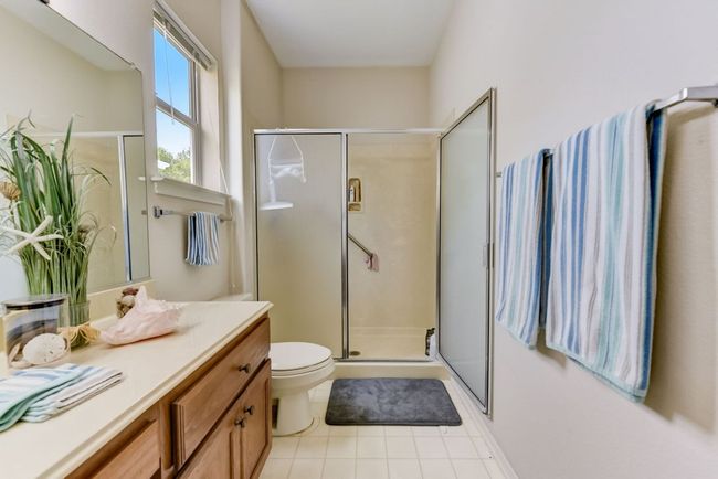 Bathroom featuring toilet, tiPrimary Bathroom: "Relax and unwind in your private en-suite bathroom—designed for comfort and convenience. ???? #BathroomBliss #PersonalOasis"le patterned flooring, vanity, and a shower stall | Image 13
