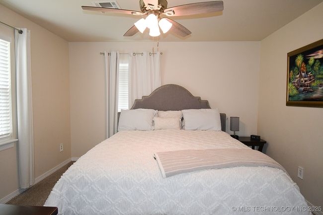 Bedroom with carpet floors, a ceiling fan, and baseboards | Image 18