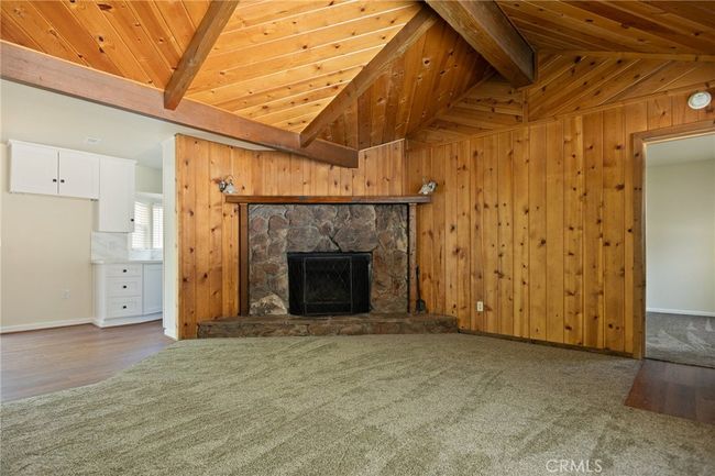 Cozy fireplace in open beamed living room | Image 6