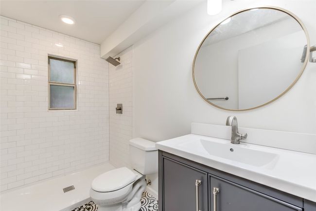 Bathroom with toilet, vanity, tiled shower, and recessed lighting | Image 10