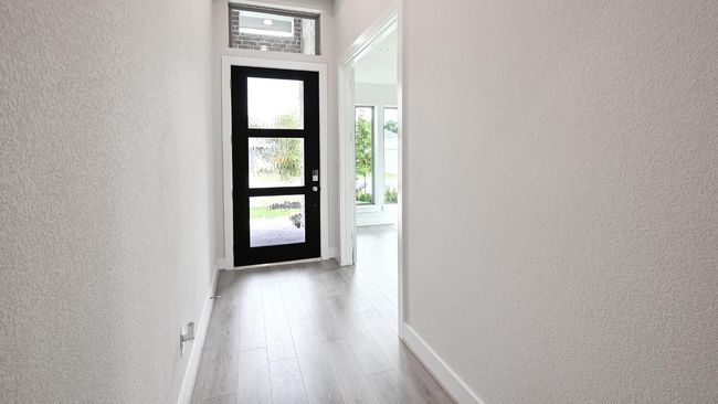Doorway to outside with a textured wall and wood finished floors | Image 14