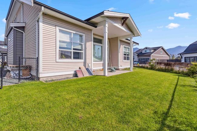 Back of house featuring a yard, a patio, and fence | Image 13