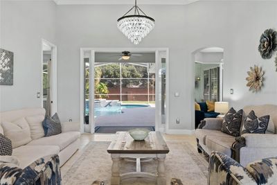 Formal living room open to pool and outdoor area | Image 3