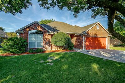 View of front of home featuring a front lawn and a garage | Image 1