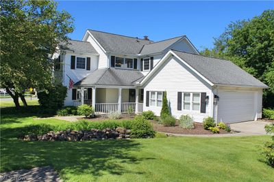 View of front of home featuring a front lawn, a garage, and a porch | Image 1