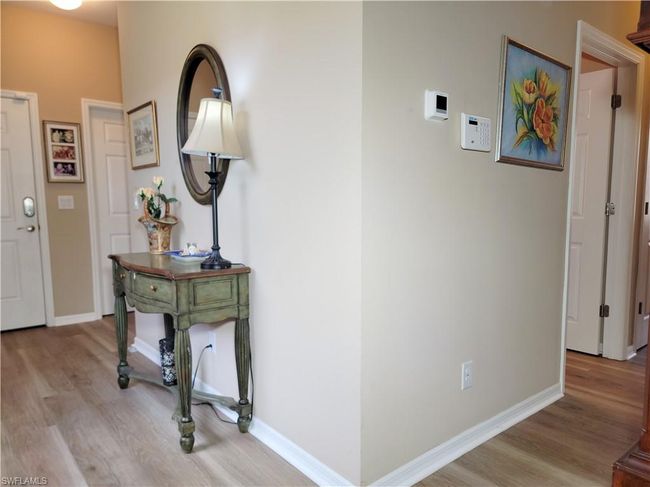 Entrance foyer featuring baseboards and wood finished floors | Image 9