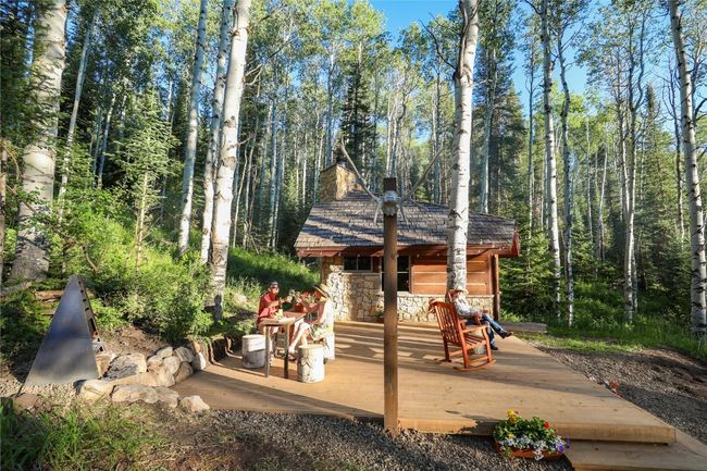 Visit the rustic Hermitage cabin nestled in a pine and aspen forest. | Image 12