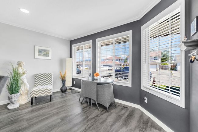 Office space featuring ornamental molding, visible vents, recessed lighting, wood finished floors, and baseboards | Image 6