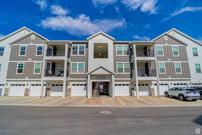 Multi unit property with a garage and board and batten siding | Image 18