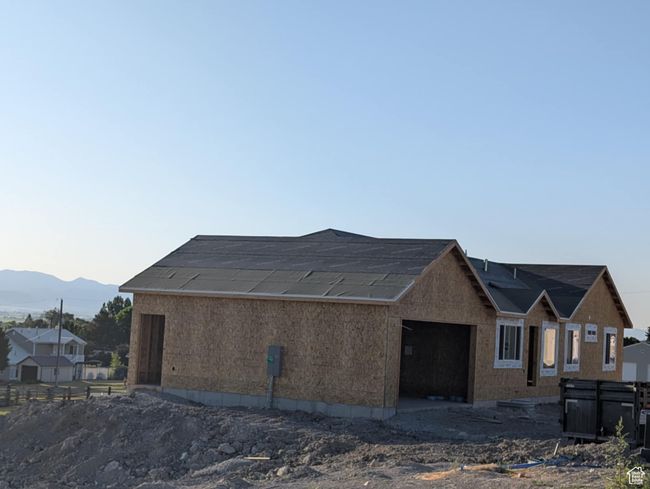 View of property exterior featuring an attached garage and a mountain view | Image 6