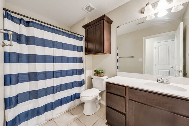 Bathroom featuring tile patterned flooring, vanity, visible vents, and toilet | Image 16