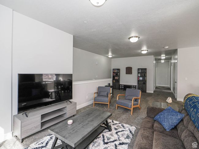 Living area with baseboards, carpet flooring, and a textured ceiling | Image 9