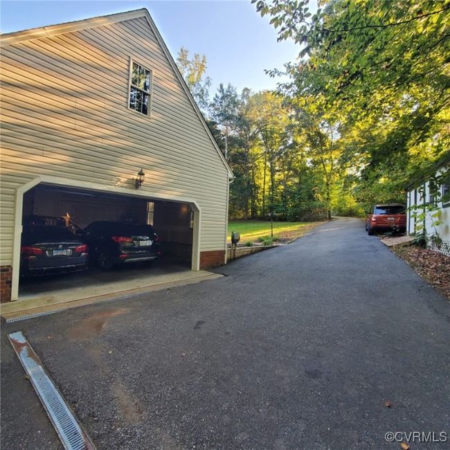View of property exterior featuring aphalt driveway | Image 9