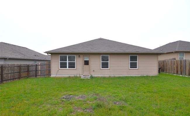Rear view of house featuring a yard, entry steps, and a fenced backyard | Image 21