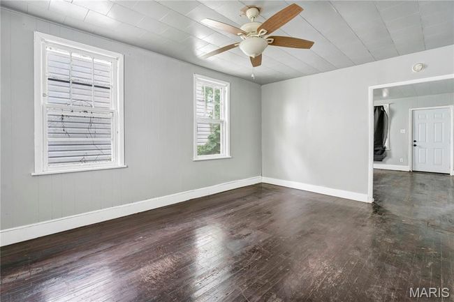 Empty room featuring wood-type flooring and a ceiling fan | Image 9