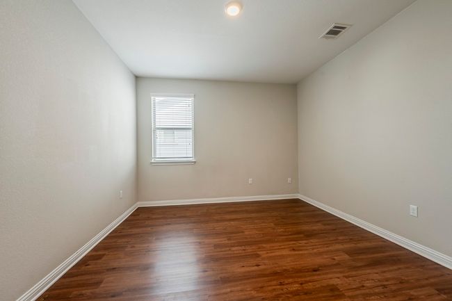 Empty room featuring baseboards, visible vents, and dark wood-type flooring | Image 31