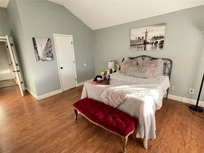 Bedroom featuring hardwood / wood-style floors and vaulted ceiling | Image 12