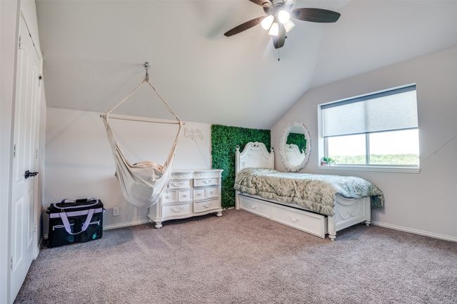 Carpeted bedroom with lofted ceiling and ceiling fan | Image 20