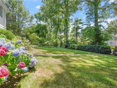 The front yard includes lush landscaping. | Image 3