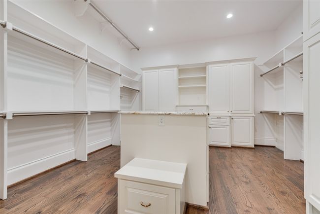 Spacious closet with dark wood-type flooring | Image 27