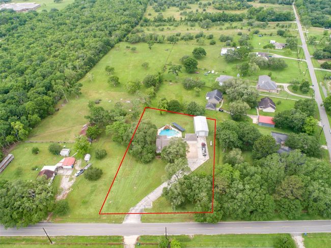Tucked away on 1.5 serene acres in Manvel, this distinctive property is built for the way you want to live. The flexible floorpan allows between 4 to 6 bedrooms, 2.5 baths, a 2-car garage, in-ground pool, plus a 60'x30' insulated shop. | Image 48