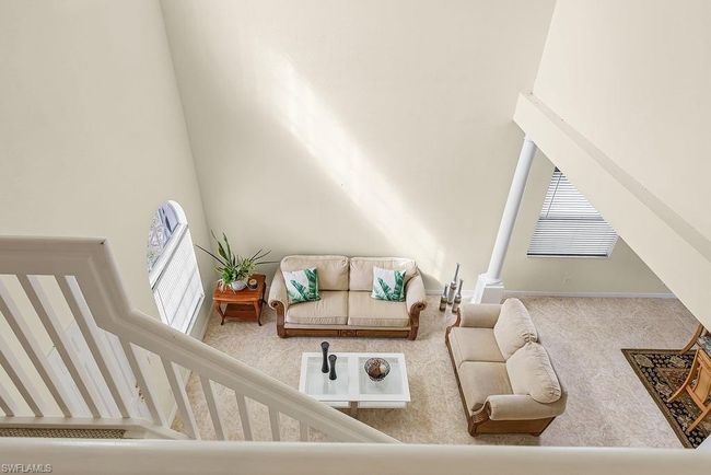 Living room with a towering ceiling and a healthy amount of sunlight | Image 30