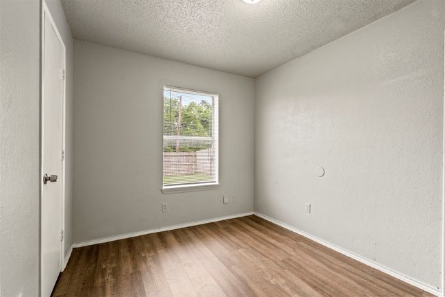 Spare room with wood finished floors, a textured ceiling, and baseboards | Image 21