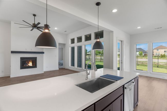 Kitchen with open floor plan, a sink, stainless steel dishwasher, light countertops, and recessed lighting | Image 27