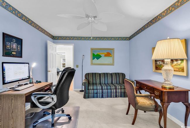 Home office with a ceiling fan and carpet floors | Image 15