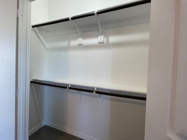 Closets featuring double rods with shelves and wood-style floors | Image 22