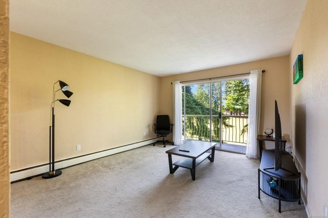 Living area featuring carpet floors and a baseboard heating unit | Image 10