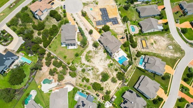 Aerial view of property and surrounding area with a pool area and nearby suburban area | Image 11