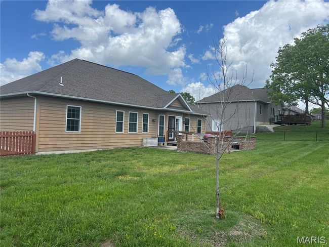 Rear view of property featuring a patio and a shingled roof | Image 22