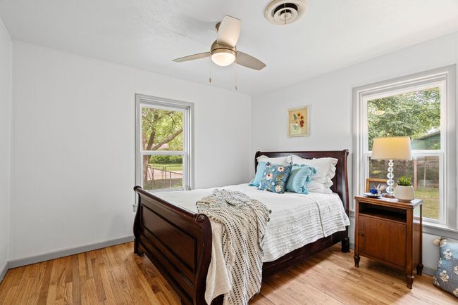 Bedroom featuring light wood-style flooring and a ceiling fan | Image 24