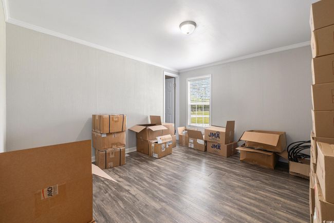 Misc room featuring ornamental molding and dark wood-style floors | Image 20