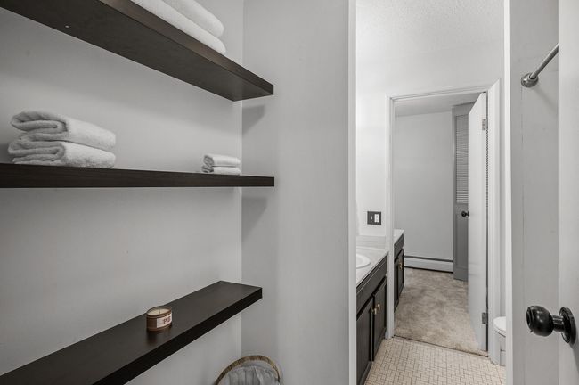 Built-in floating shelves provide stylish and functional storage. | Image 18