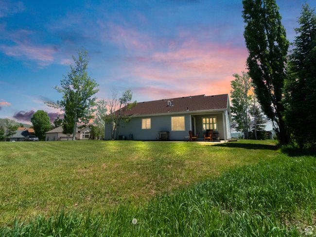 Back of house featuring a yard and a patio area | Image 52