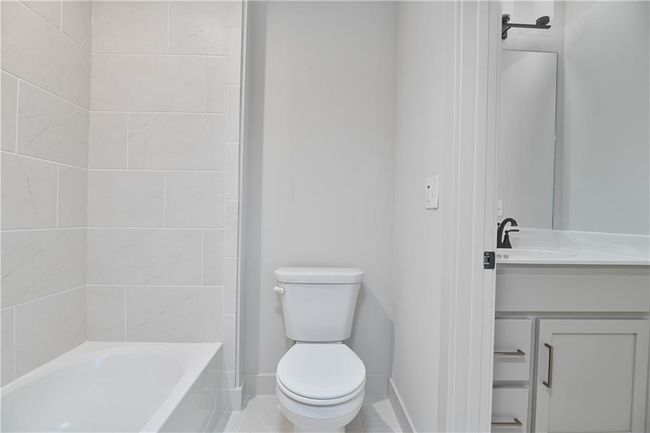 Bathroom featuring tile patterned floors, toilet, and vanity | Image 42