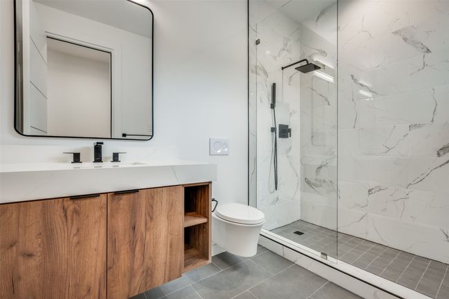 Bathroom featuring vanity and a marble finish shower | Image 26