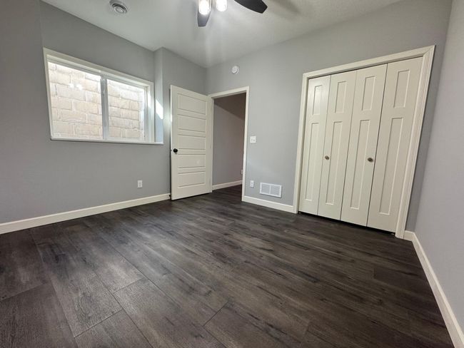 LL Bedroom #5 Features LVP Floor, fresh paint, and ceiling fan. | Image 20