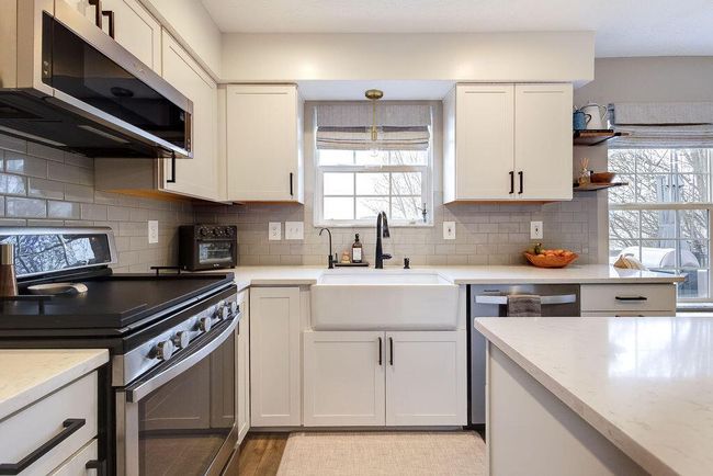 Beutiful Kitchen showcasing large island, subway tile, and apron front sink. | Image 4