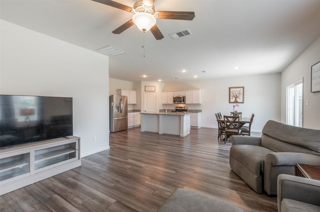 Living room featuring ceiling fan, recessed lighting, dark wood-style flooring, and baseboards | Image 12