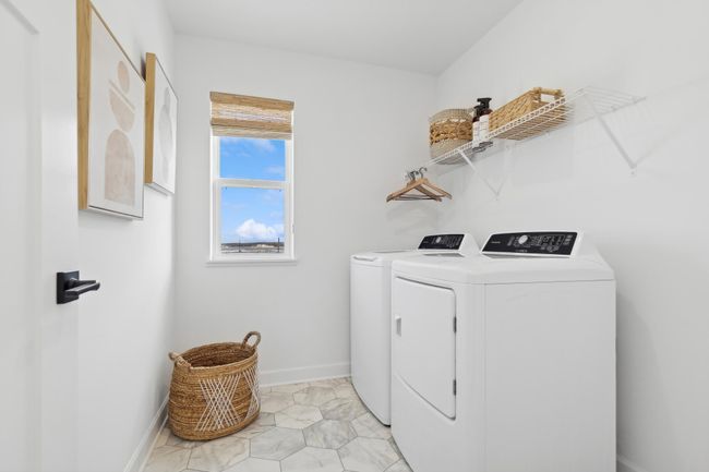 (Photo of a decorated model, actual homes finishes will vary) Upper level laundry. | Image 17