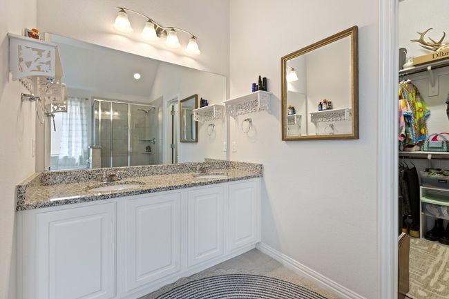 Full bath with double vanity, tile patterned flooring, a stall shower, and a sink | Image 18