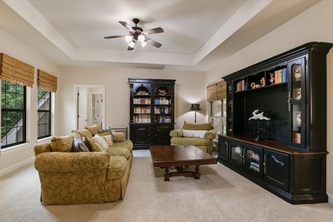UPSTAIRS family/game room area with a tray ceiling, plenty of natural light, and ceiling fan. Just around the corner from the Kitchenette. | Image 19
