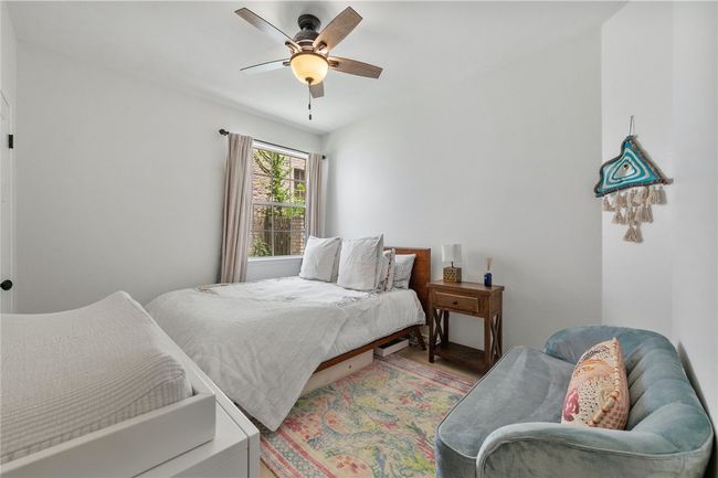 The third bedroom is well-sized with a ceiling fan and a walk-in closet. | Image 19