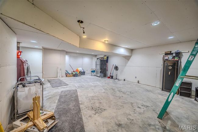 Finished basement with separate washer and dryer and recessed lighting | Image 50