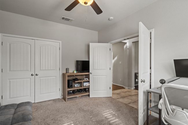 Carpeted home office featuring ceiling fan | Image 9