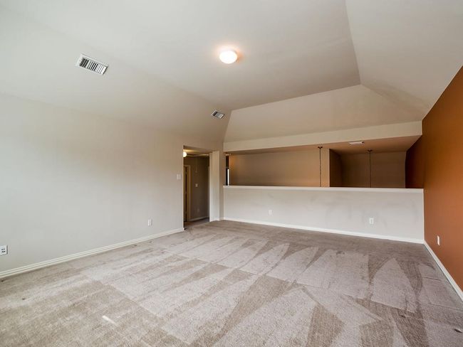 Carpeted spare room with vaulted ceiling and baseboards | Image 35