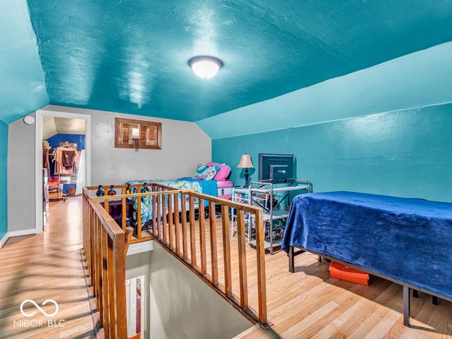 Loft with baseboards, vinyl plank flooring, a textured ceiling, and vaulted ceiling | Image 15